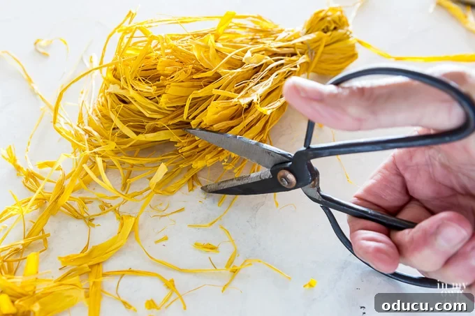 Craft Your Own Tassels: Elevate Your Home Decor 18 cutting bottom end of raffia tassel with scissors