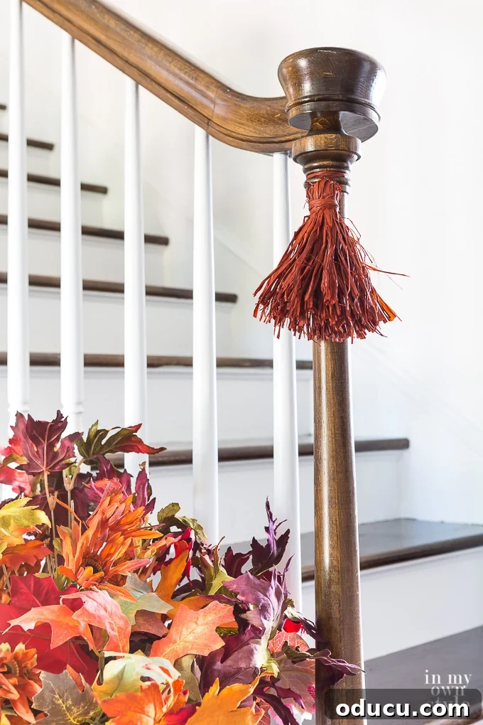 Craft Your Own Tassels: Elevate Your Home Decor 20 How to make raffia tassels for fall decorating. Fall staircase decorating idea.