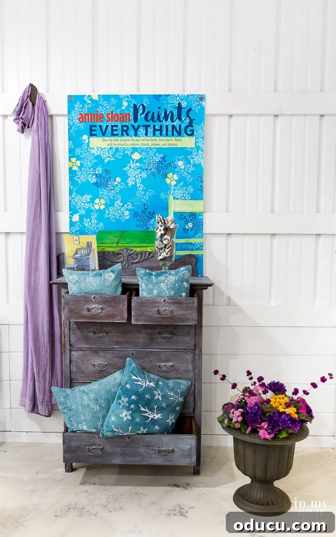 Annie Sloan demonstrating how to create a chippy distressed finish on furniture.