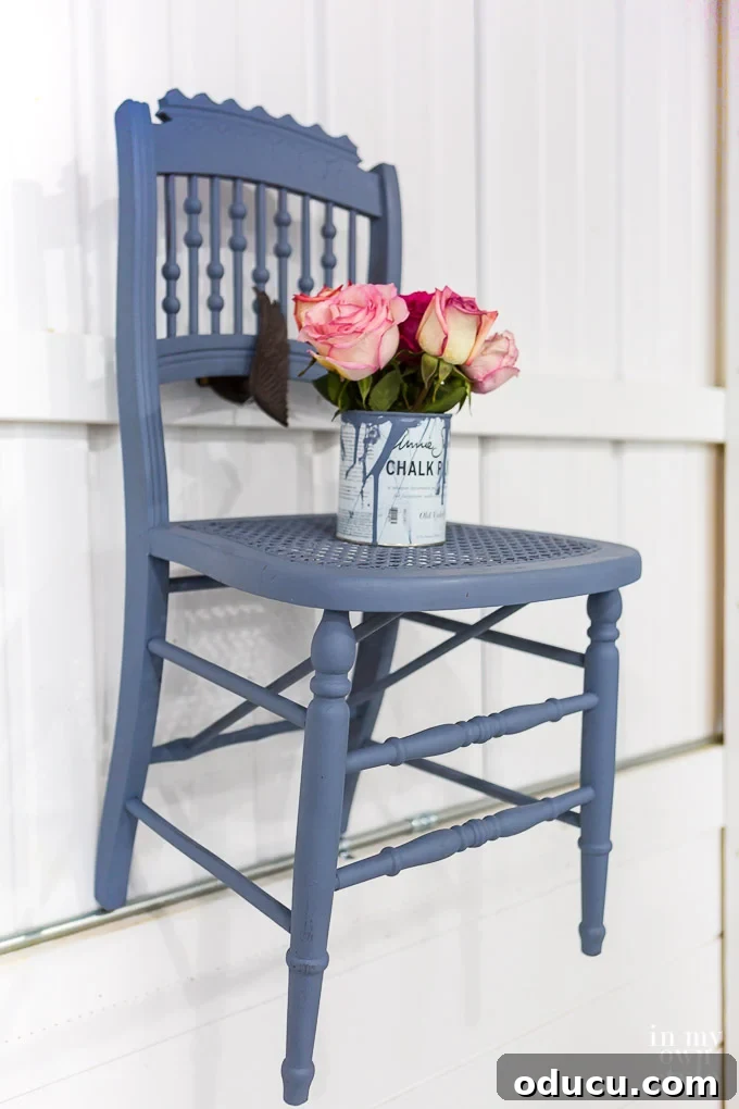 A close-up of applying Annie Sloan wax with a dedicated brush for a smooth finish.