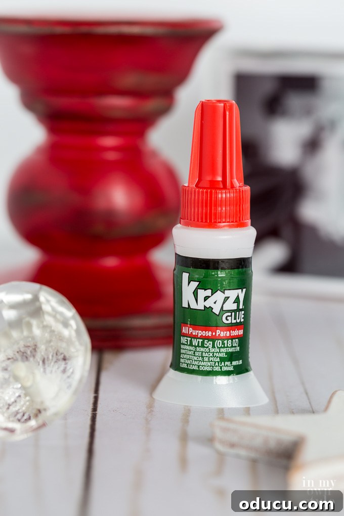 Elevated Christmas Photo Keepsake 15 Applying Krazy Glue to photo cube and pedestal