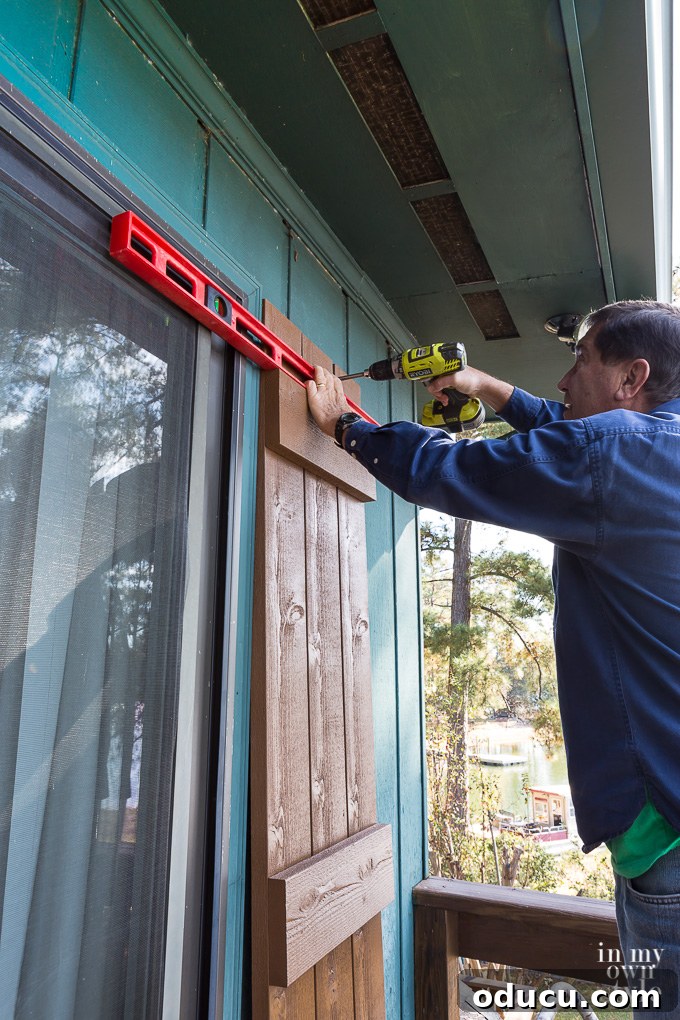 Elevate Your Curb Appeal Nu-Wood Exterior Makeover 15 Positioning and leveling Nu-Wood shutters on a house exterior