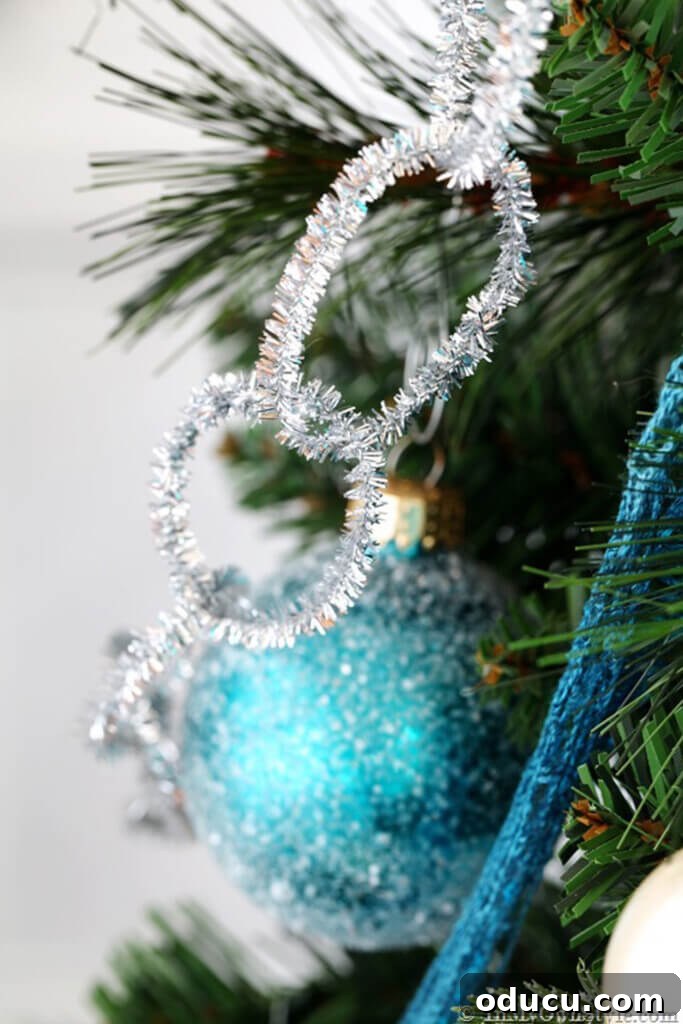 Sparkly Silver pipe cleaner garland and turquoise ornaments on Christmas tree.