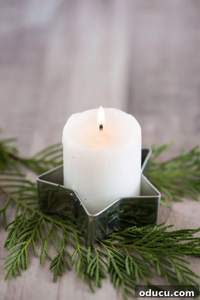 A votive candle placed inside a metal cookie cutter makes for fast and easy Christmas decor
