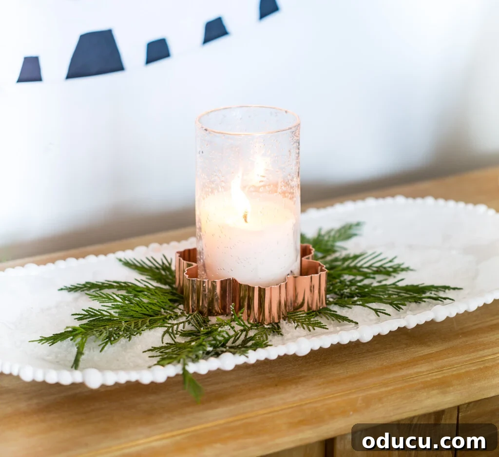 Candle placed inside a copper snowflake cookie cutter on a tray of salt makes for easy to do last minute Christmas decorating