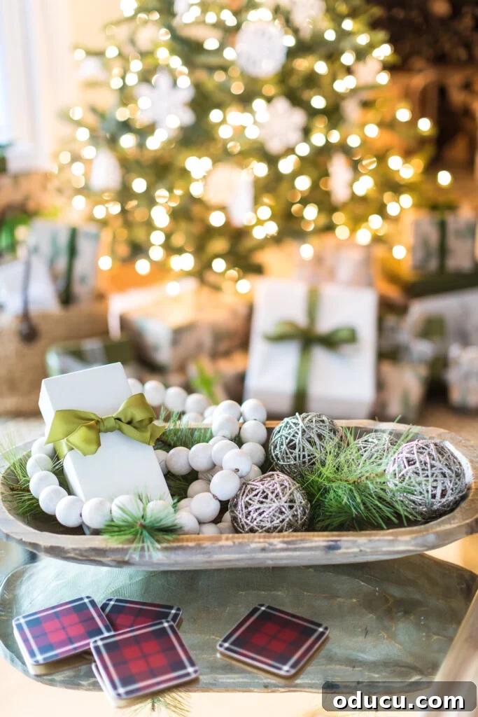 Large dough bowl on table decorated for Christmas.