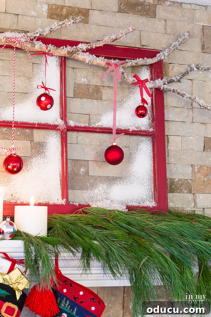 Frosted Window Mantelscape 20 Christmas mantel decorating idea that uses an old window sash and tree branch.