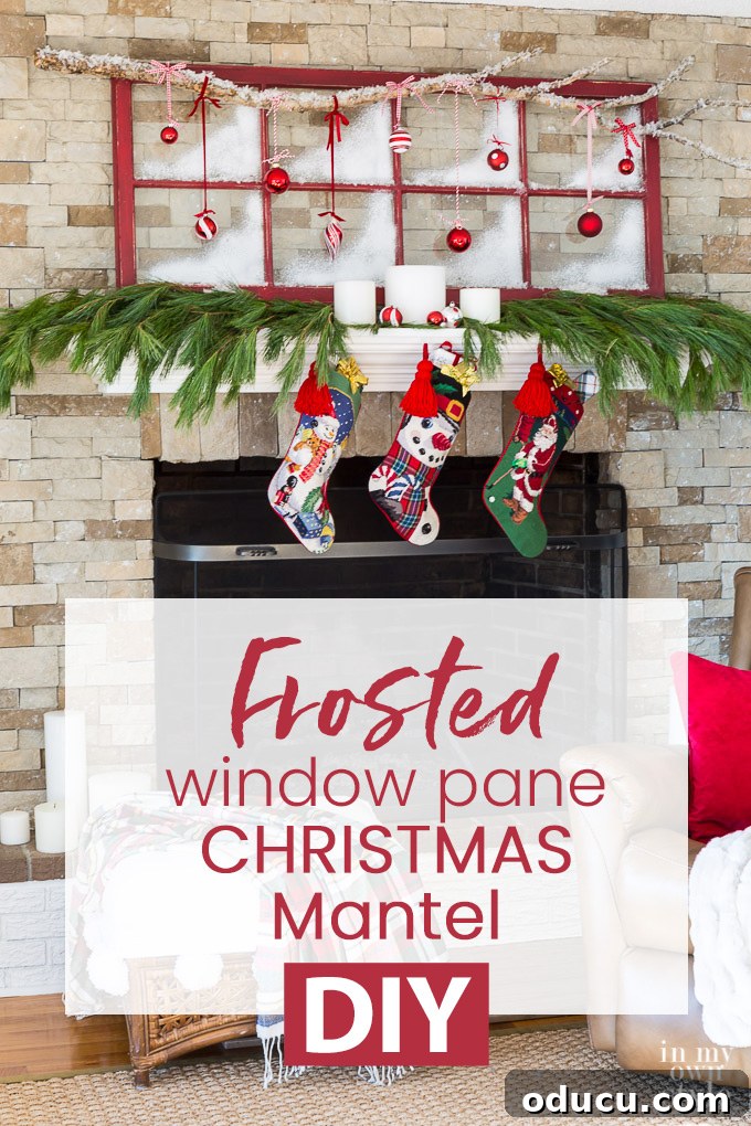 Christmas mantel decorating idea uses an old window sash or door insert. Step-by-step photo tutorial shows you how to make it. #christmas #mantels #mantle #christmasdecorations #christmasDIY Christmas decorated mantel using an old red window sash and ornaments