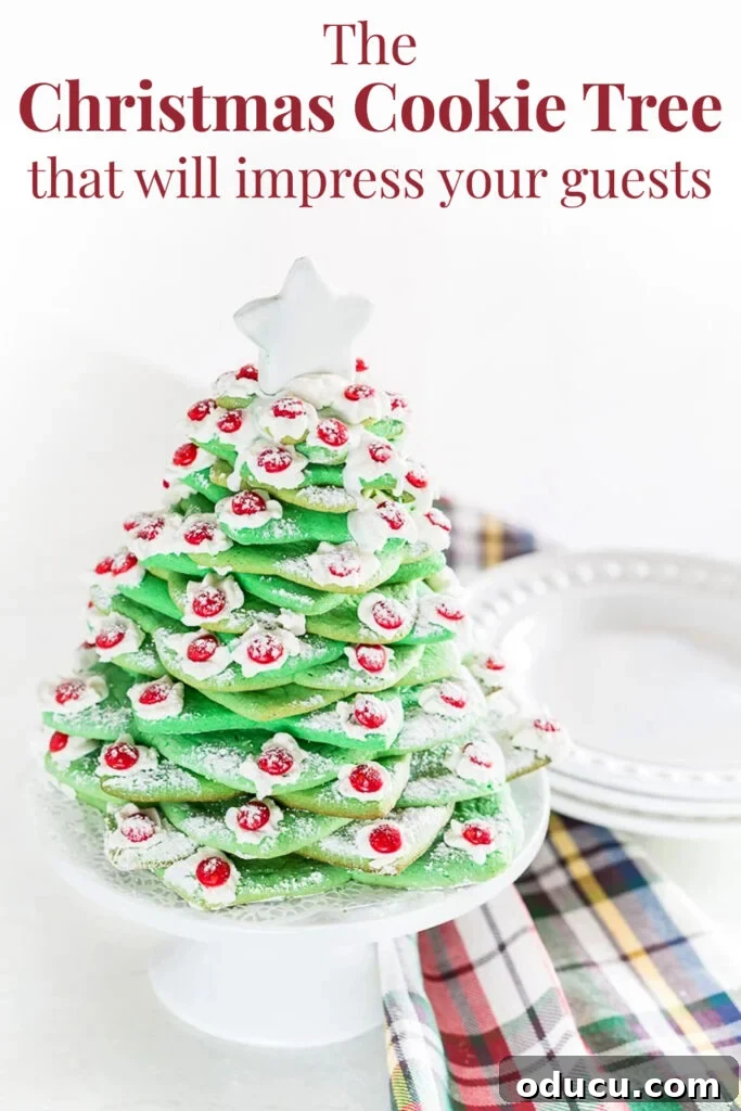 Deck the Halls with Edible Cookie Trees 13 A majestic Christmas cookie tree on a kitchen counter, beside a festive plaid dishcloth. Overlay text reads: 'The Christmas cookie tree that will impress your guests.'