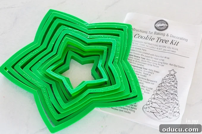 Deck the Halls with Edible Cookie Trees 3 Wilton Christmas cookie tree kit displayed on a surface, featuring various star-shaped cookie cutters.