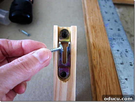screw-to-use-for-brackets Wood screw partially inserted into window sash.