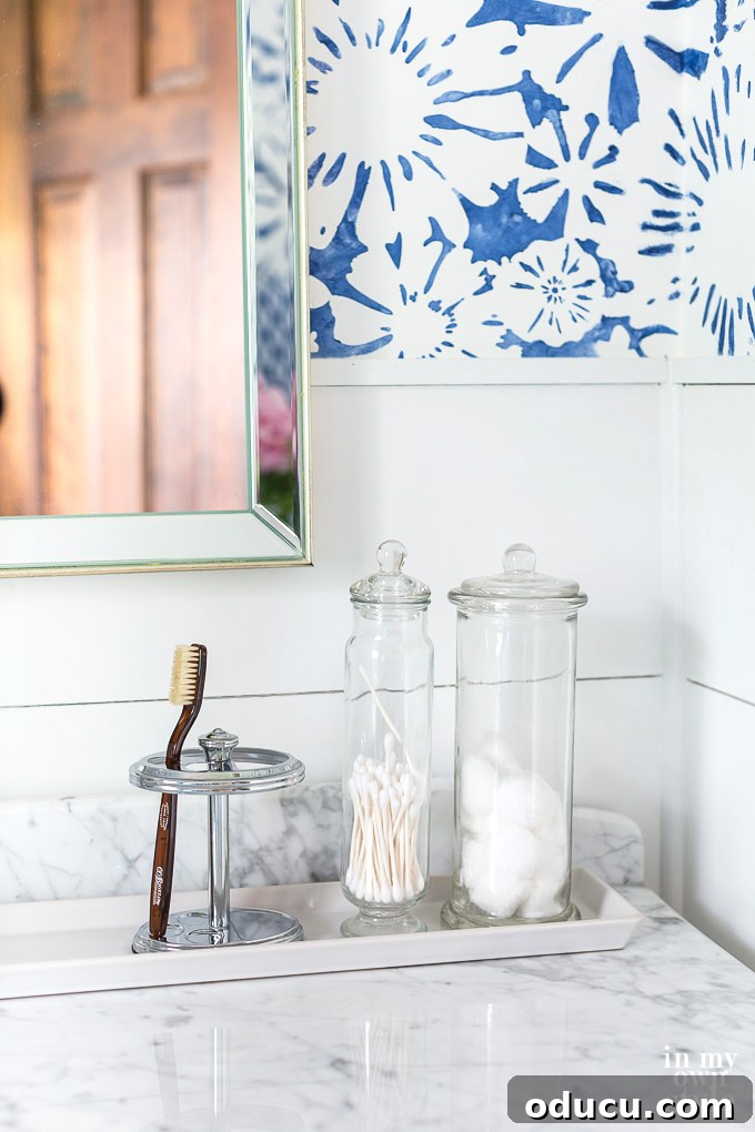 Curating Your Home Decor Capsule 5 Decorating a bathroom with blue and white accents using versatile glass canisters for storage and style.