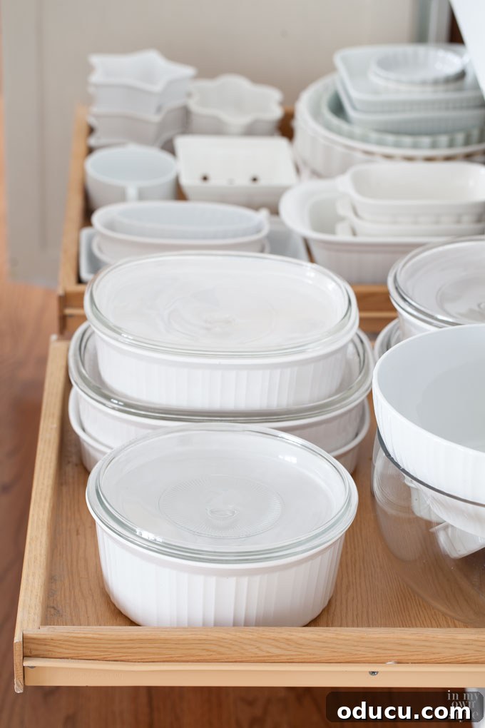 Curating Your Home Decor Capsule 10 Organizing behind the scenes: a glimpse into kitchen cabinets filled with versatile white dishes.