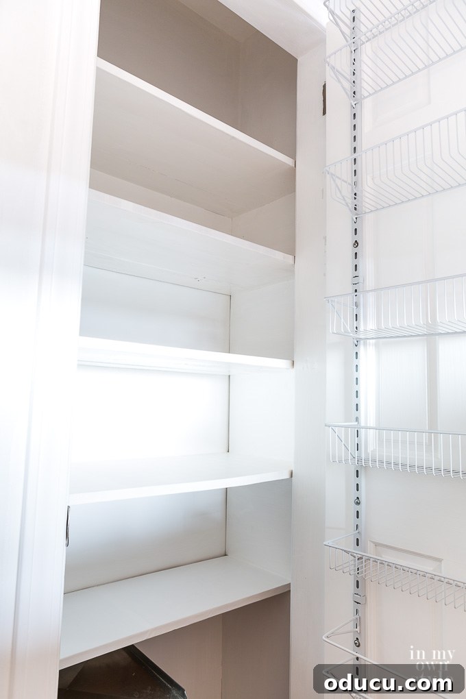 Pantry Closet Transformation 12 The newly organized pantry interior after painting, with a clean and bright appearance
