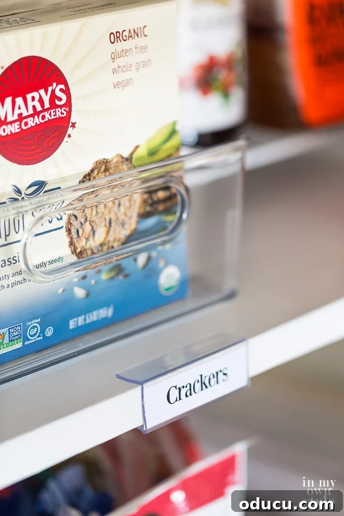 Pantry Closet Transformation 19 Clear shelf label holders positioned on the front edge of a pantry shelf, indicating movability