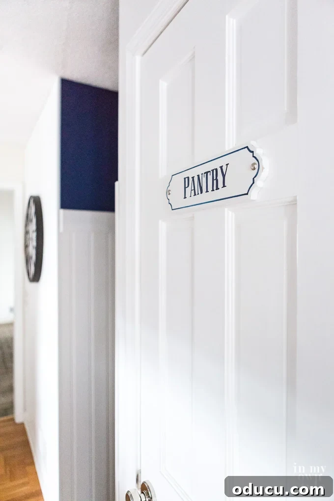 Pantry Closet Transformation 8 Close-up of the new solid pantry door featuring a decorative 'Pantry' sign