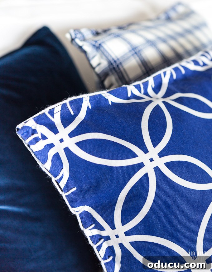 Turn Cloth Napkins into Unique Throw Pillow Covers 7 A close-up of a blue and white throw pillow cover made from cloth napkins, highlighting the simple hand-stitching technique.