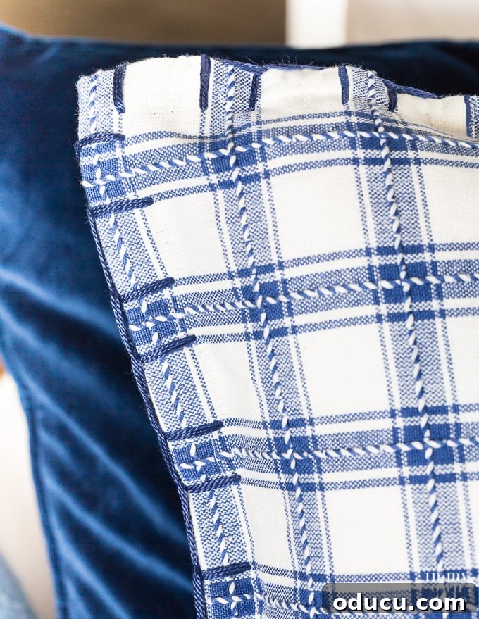 Turn Cloth Napkins into Unique Throw Pillow Covers 16 A finished pillow cover made using cloth napkins and a blanket stitch to attach them together, demonstrating the completed DIY project.