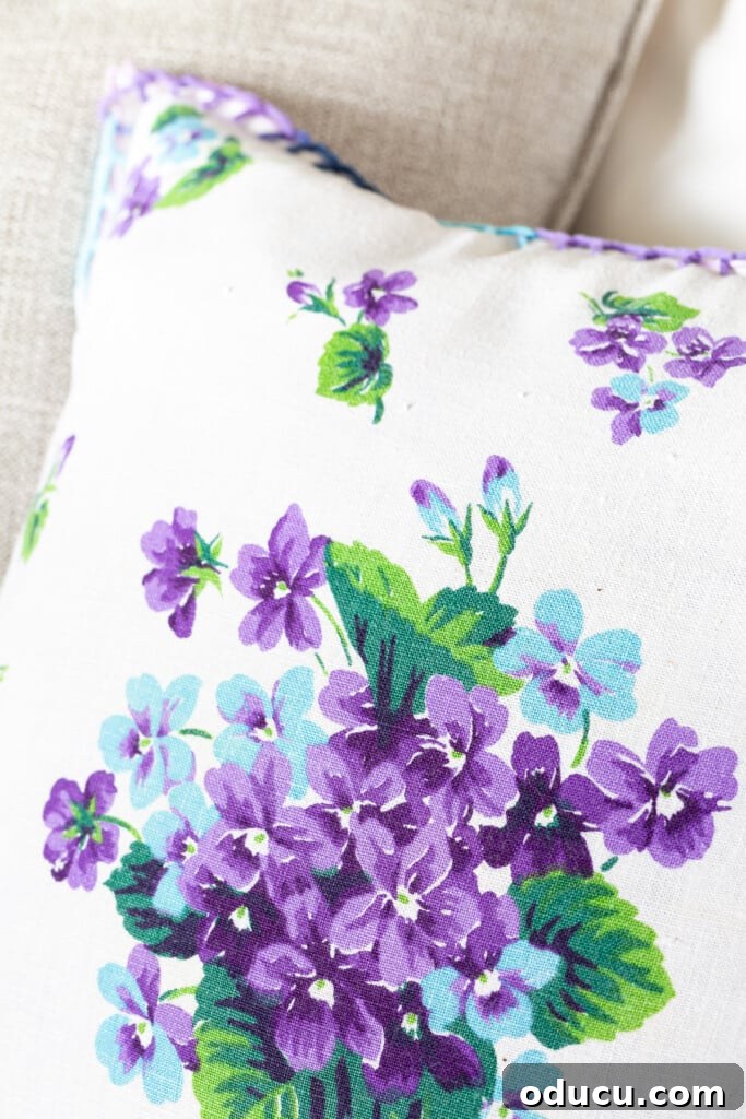 Turn Cloth Napkins into Unique Throw Pillow Covers 4 Close-up detail of a floral pattern on a vintage linen napkin, emphasizing its beauty and suitability for DIY accent pillows.