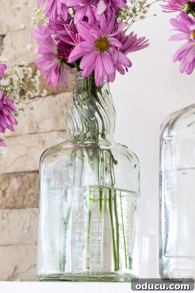 From Old to New: Spring Mantel Decor with Upcycled Finds 4 Budget-friendly spring mantel decorating ideas using recycled glass bottles destined for the trash