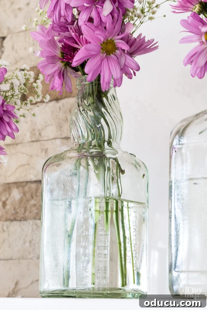 Upcycled Blooms: Spring Mantel Decor 4 Budget-friendly Spring mantel decorating ideas using recycled glass bottles destined for the trash