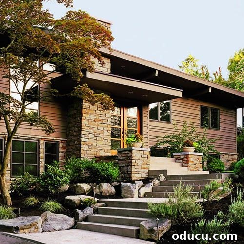 Modern home exterior with large boulders and minimalist landscaping