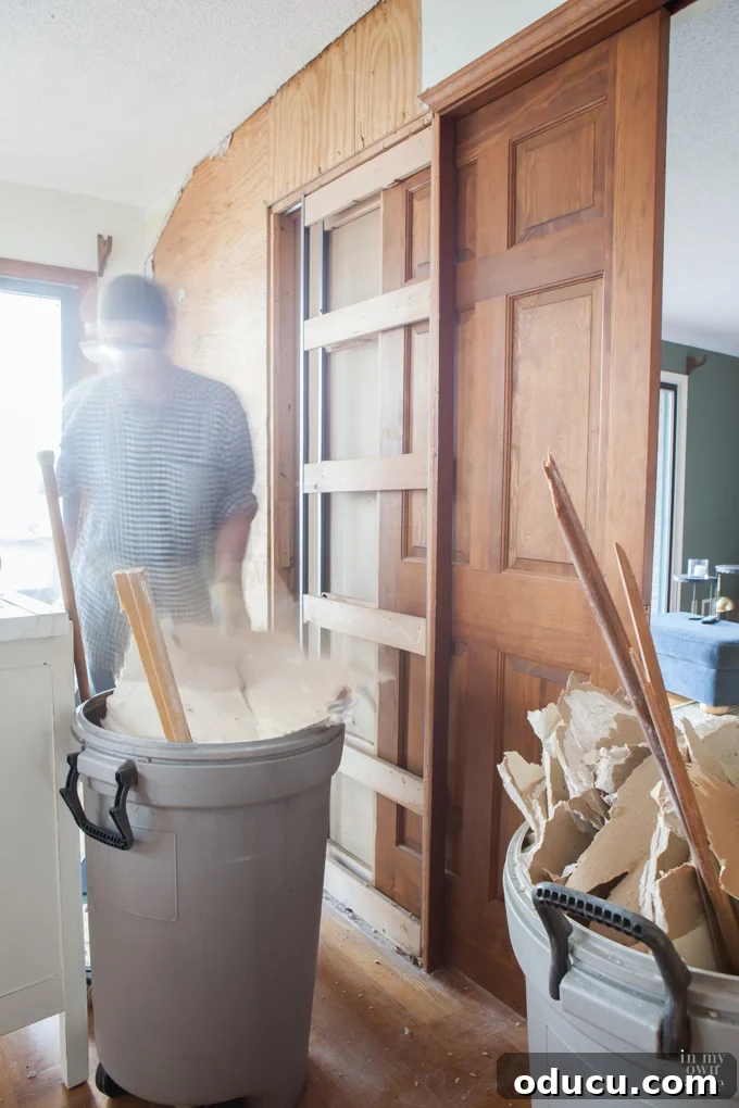 The Inaccessible Game Den 4 Pocket door being removed from a wall during an earlier renovation, now destined for a new life in the game room.