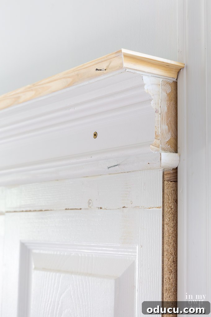 Creative crown molding trim idea for the top of a headboard made using old doors