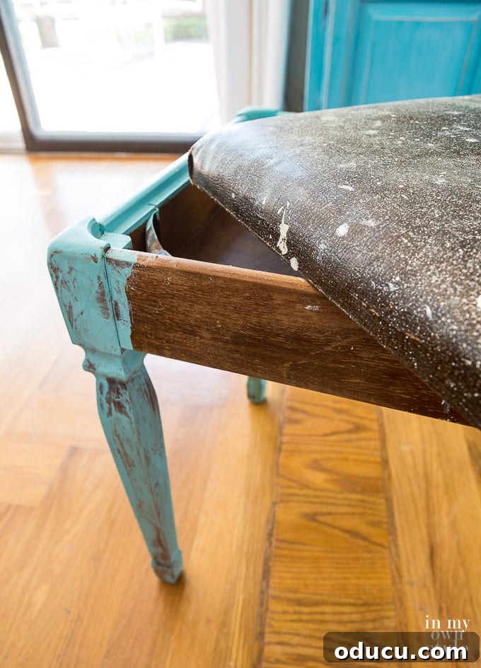From Neglected Stool to Elegant Ottoman 13 Stool before makeover showing its top lifted off to reveal storage space inside, highlighting its design.