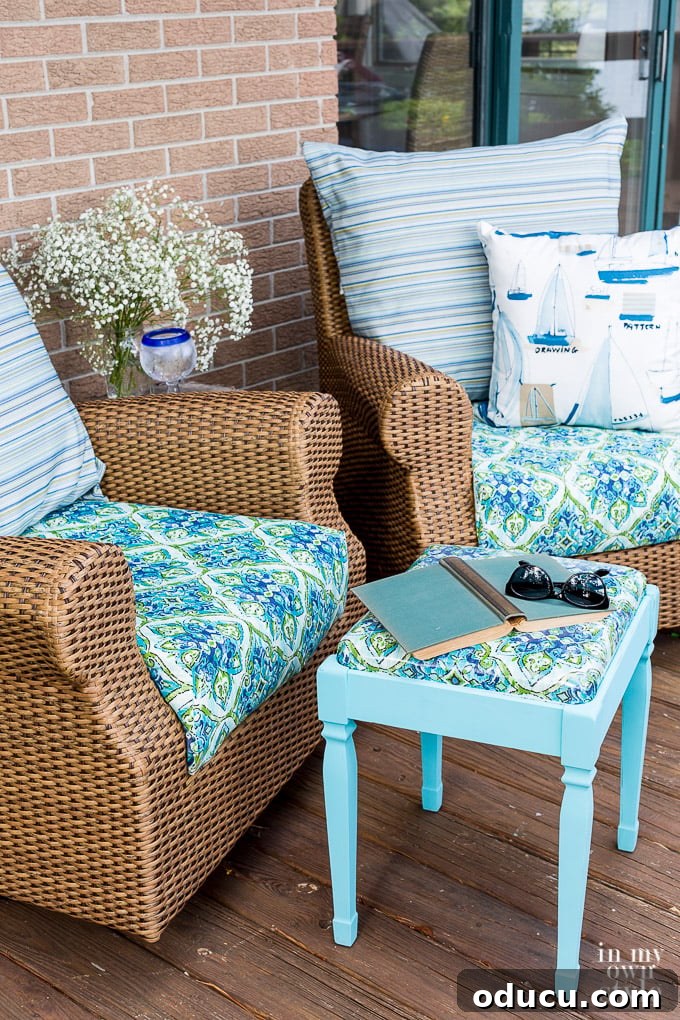 From Neglected Stool to Elegant Ottoman 15 Two rattan chairs with the transformed stool between them, styled with a book and sunglasses, ready for use.