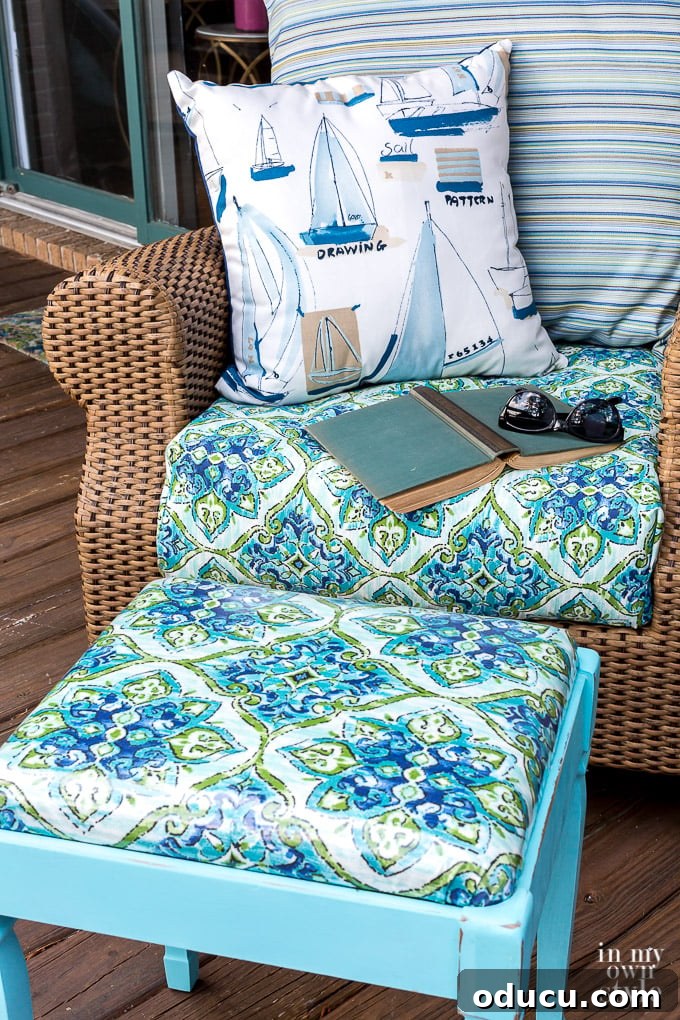 From Neglected Stool to Elegant Ottoman 6 Close up of the newly covered stool next to a rattan rocker, with matching fabric on the stool cushion.