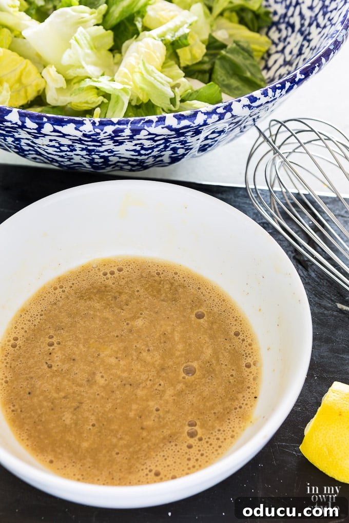 The Ultimate Anchovy-Free Caesar Salad 6 Bowl of Cesar salad ingredients just whisked to combine them.