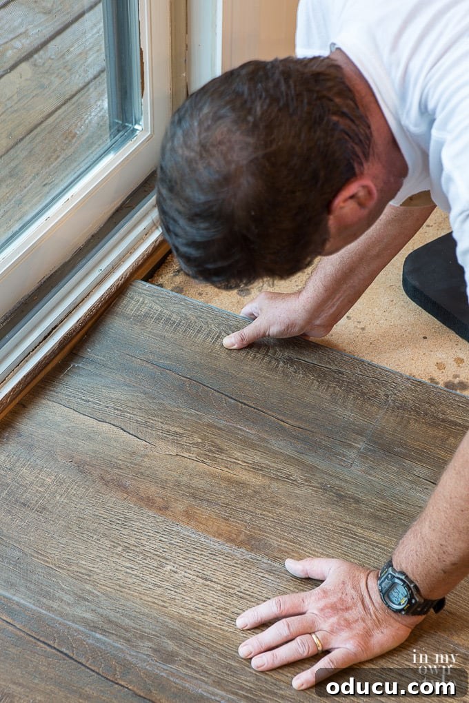 Close-up of luxury vinyl plank interlocking system during installation