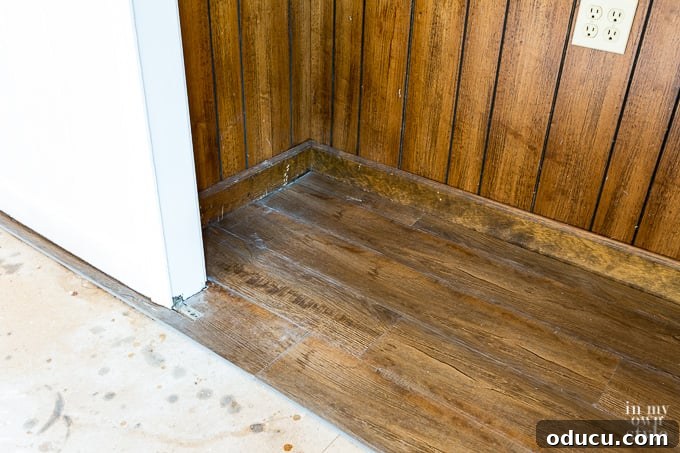 Careful fitting of LVP plank around a door jam for a perfect fit