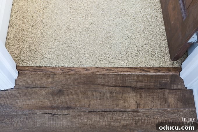 Wood threshold for flooring transition from LVP to carpet