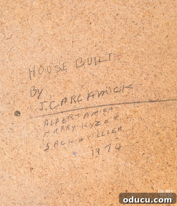 Detailed view of subfloor after carpet removal, revealing historical notes