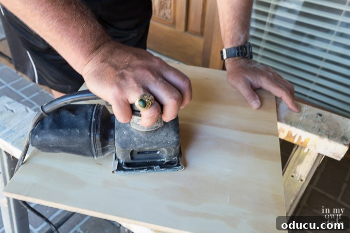 Build a Stunning Stacked Donut Wedding Centerpiece 14 Sanding the edges of a plywood board