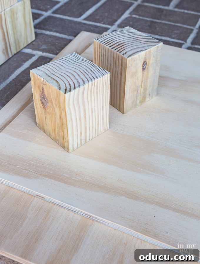 Build a Stunning Stacked Donut Wedding Centerpiece 16 Wiping down sanded wood with a damp rag