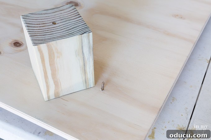 Build a Stunning Stacked Donut Wedding Centerpiece 25 Screwing a wood screw into the largest board from the top