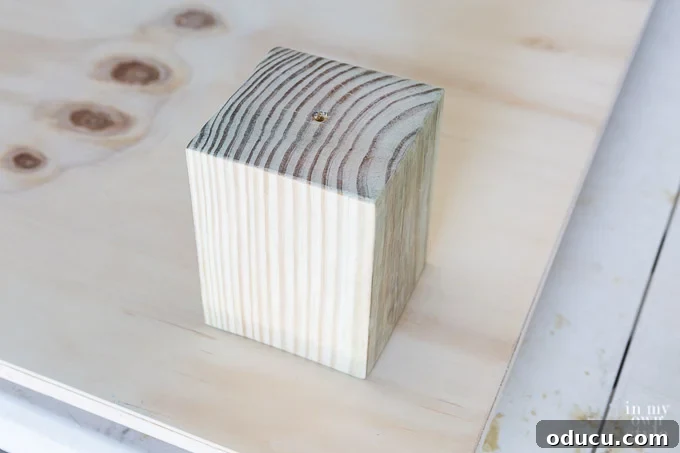 Build a Stunning Stacked Donut Wedding Centerpiece 26 Wood screw emerging from the bottom of the largest board