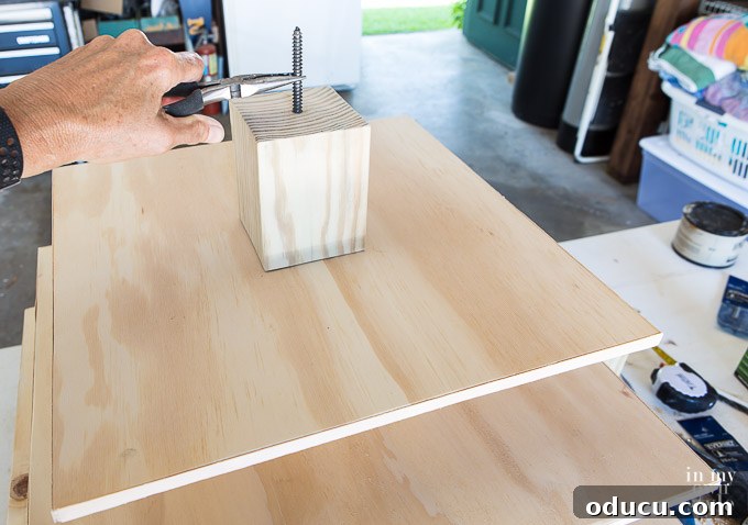 Build a Stunning Stacked Donut Wedding Centerpiece 30 Preparing to attach a dowel screw to a riser block