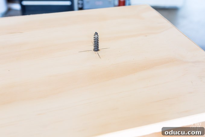 Build a Stunning Stacked Donut Wedding Centerpiece 33 Attaching the next tier and riser block using a dowel screw