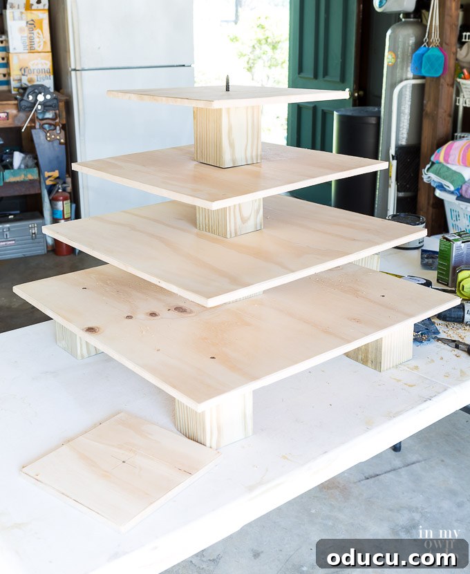 Build a Stunning Stacked Donut Wedding Centerpiece 34 Continuing to stack tiers and risers with dowel screws