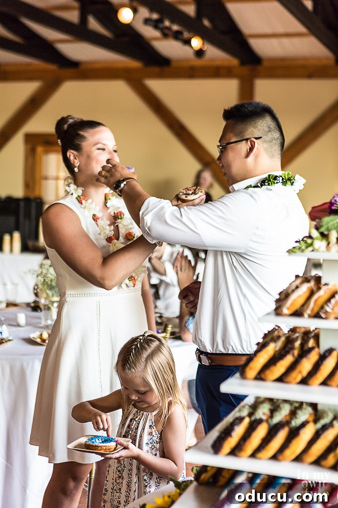 Build a Stunning Stacked Donut Wedding Centerpiece 38 Guests enjoying donuts from the DIY tiered stand at a wedding