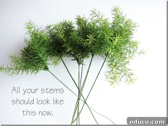 Craft Your Own Lifelike Topiary 10 Collection of faux greenery stems with branches pushed up, ready for assembly.