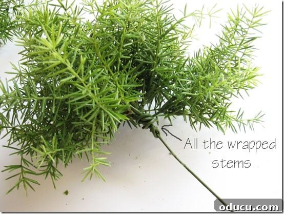 Craft Your Own Lifelike Topiary 12 Forming the clustered faux greenery into a loose, organic ball shape for the topiary.