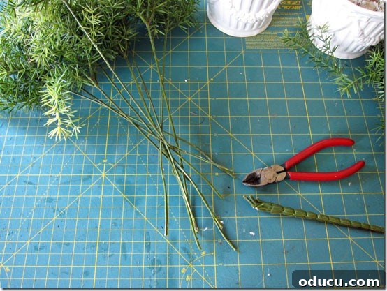 Craft Your Own Lifelike Topiary 6 Close-up of individual faux greenery stems after being cut from the main bouquet.