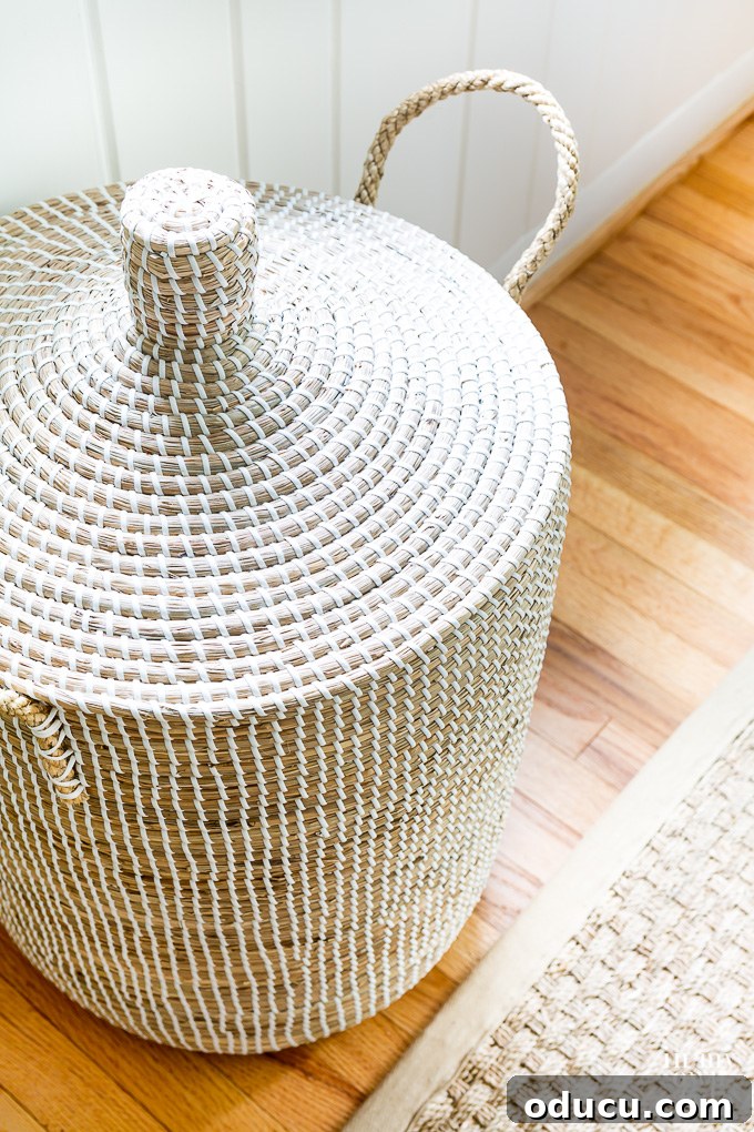 A stylish lidded basket on a hardwood floor, suggesting organized living and decluttering for a home makeover.