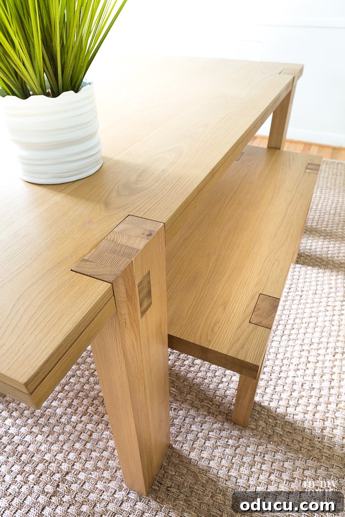 A close-up view of a modern West Elm dining table, highlighting its sleek design and the minimalist aesthetic.