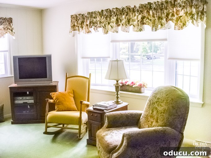 Another angle of the living room needing a decorating update, showing the extent of the previous style.